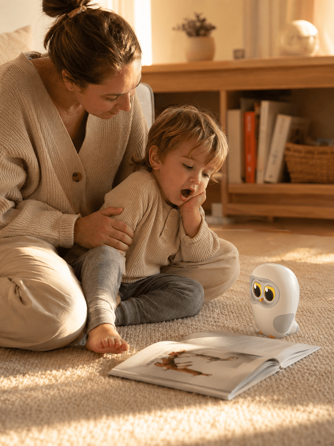 Family on the rug as Luka reads to a tired toddler